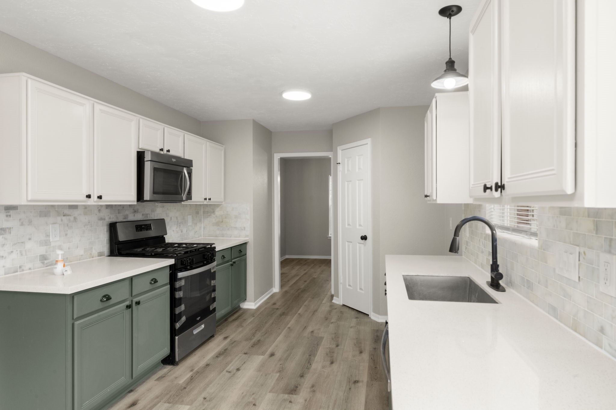 6615 Broken Stone Houston, TX 77084 - Photo 8 of 29 a kitchen with granite countertop a sink stainless steel appliances and white cabinets
