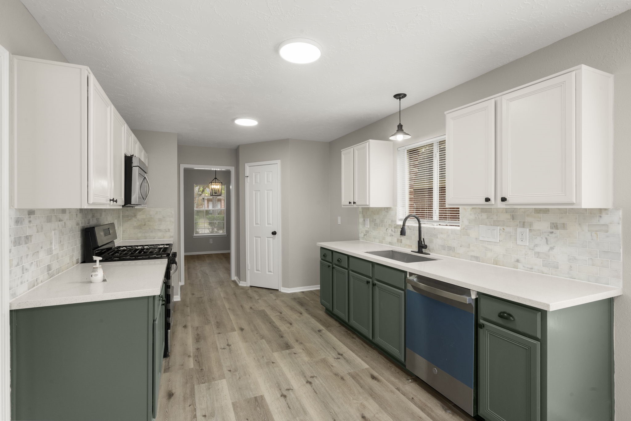 6615 Broken Stone Houston, TX 77084 - Photo 9 of 29 a kitchen with a sink stove and cabinets