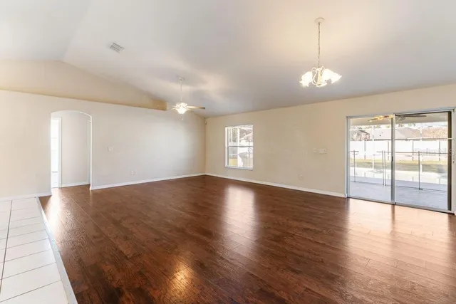 a large kitchen with stainless steel appliances a stove a sink and cabinets