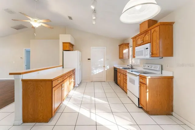 a spacious bathroom with a granite countertop sink a mirror and a shower