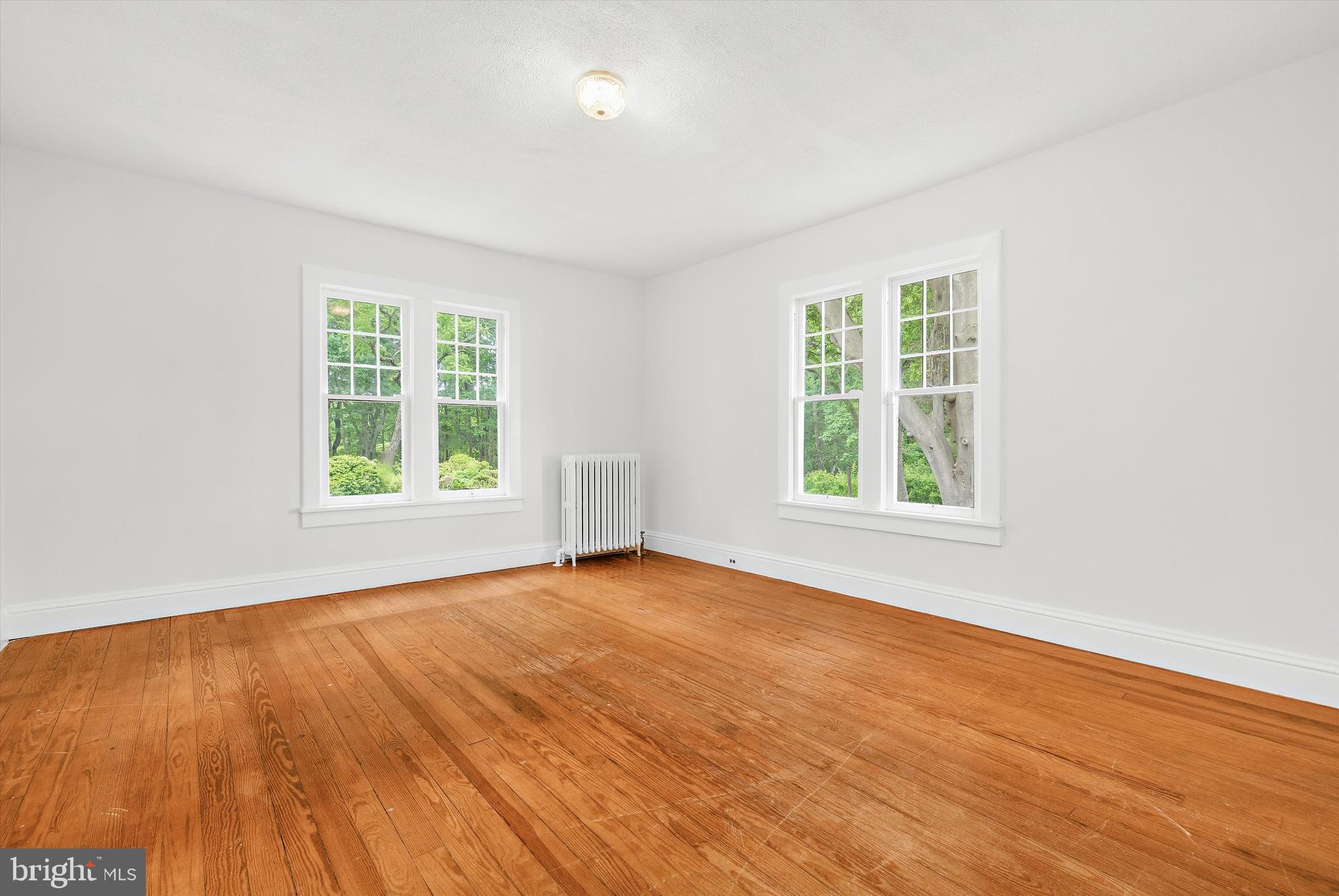 500 Nesbit Road Queenstown, MD 21658 - Photo 25 of 53 an empty room with wooden floor and windows