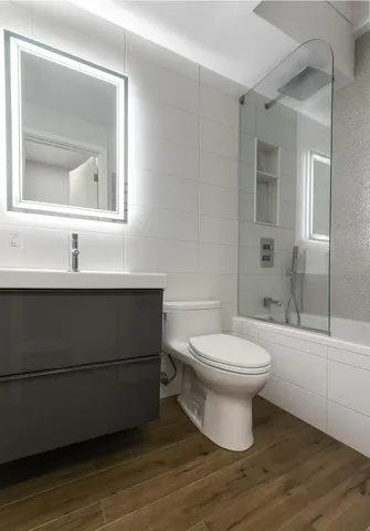 a bathroom with a toilet sink and a mirror