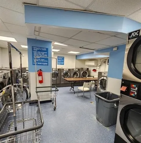 a living room with furniture a air conditioner and a table