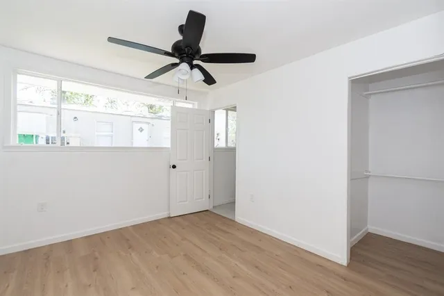 a view of a room with wooden floor and windows