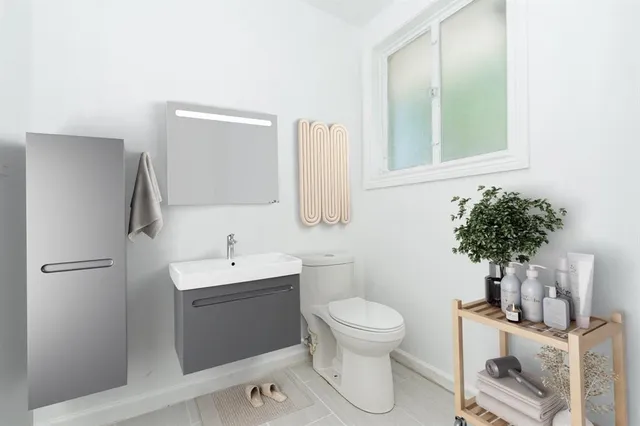 a bathroom with a sink toilet and a mirror