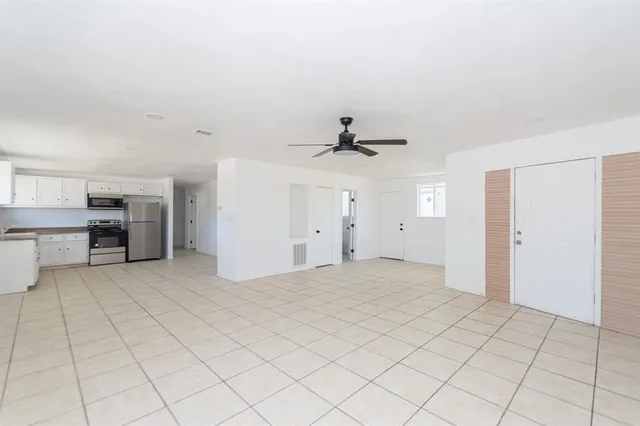 a view of a kitchen with a sink and a refrigerator cabinets