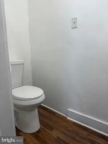 a view of a bathroom with wooden floor