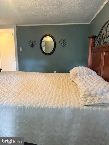 a bedroom with a bed and dresser