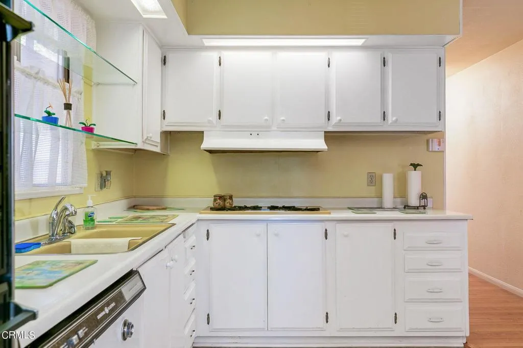 1273 South Rice Road, Unit 100 Ojai, CA 93023 - Photo 12 of 31 a kitchen with granite countertop white cabinets and white appliances