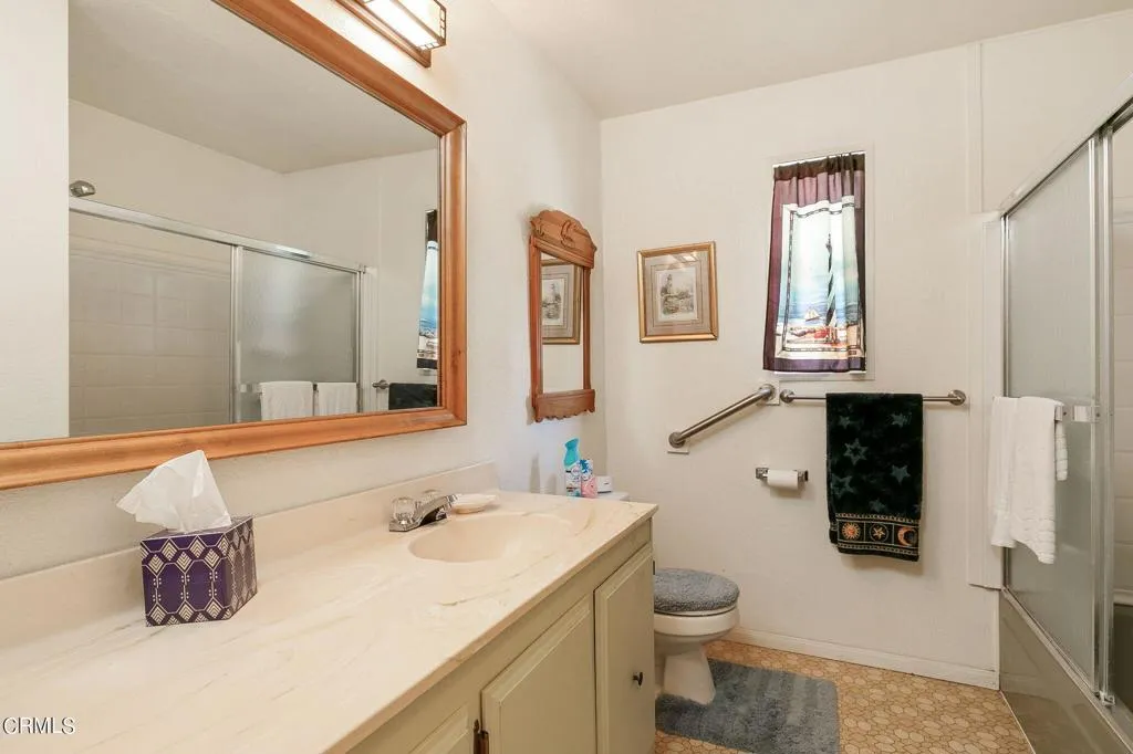 1273 South Rice Road, Unit 100 Ojai, CA 93023 - Photo 17 of 31 a bathroom with a sink a toilet and mirror