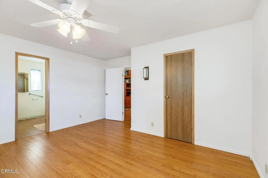 1273 South Rice Road, Unit 100 Ojai, CA 93023 - Photo 19 of 31 an empty room with wooden floor and a ceiling fan