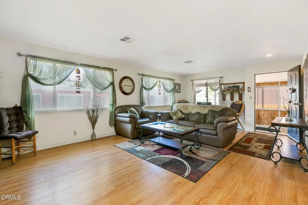 1273 South Rice Road, Unit 100 Ojai, CA 93023 - Photo 4 of 31 a living room with furniture a large window and wooden floor