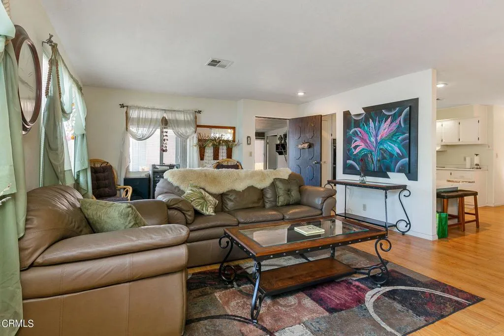 1273 South Rice Road, Unit 100 Ojai, CA 93023 - Photo 7 of 31 a living room with furniture a wooden floor and next to a window