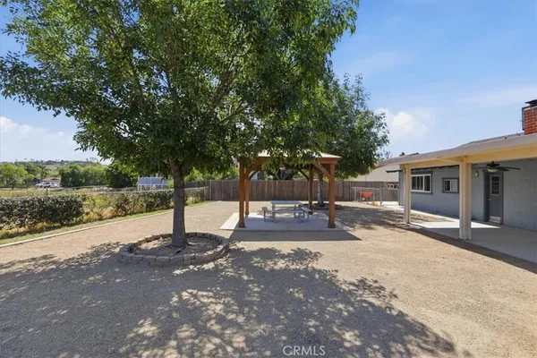 an aerial view of a house with a yard basket ball court and outdoor seating