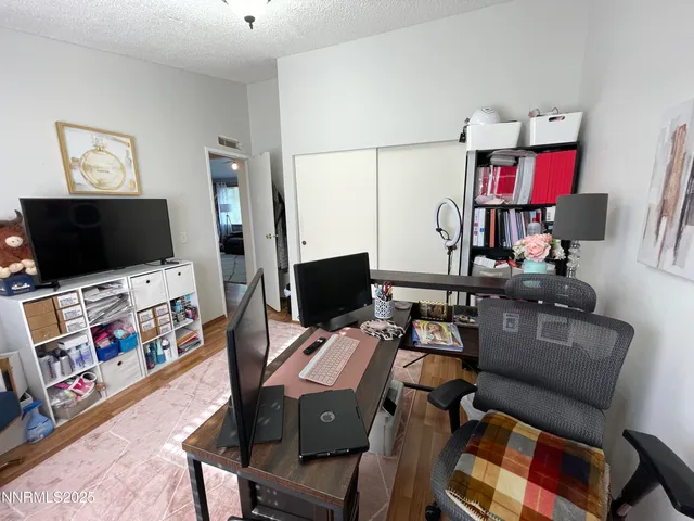 a work room with furniture and flat screen tv