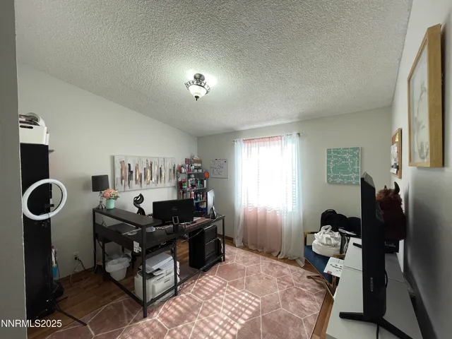 a bedroom with furniture and a window