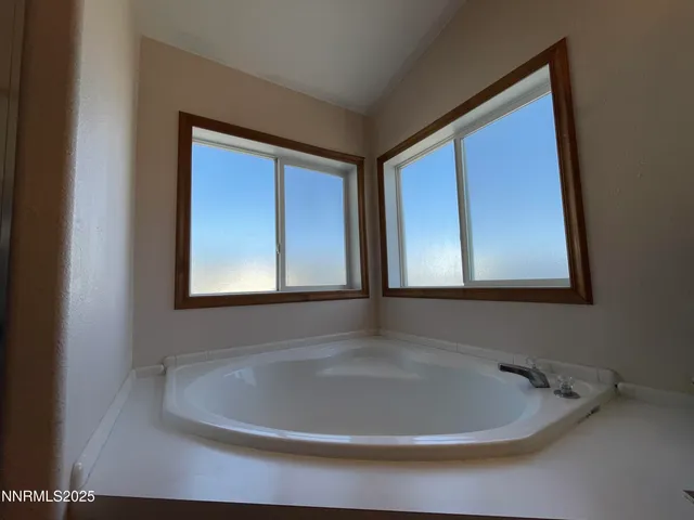 a bathroom with a bathtub and window