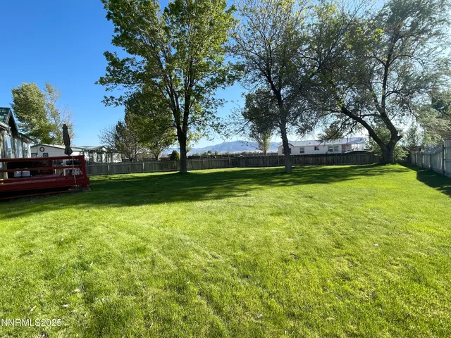 a view of yard with swimming pool and green space