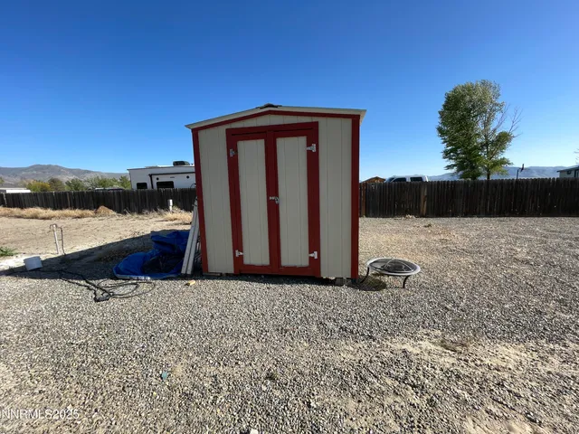 a view of wooden fence next to a road