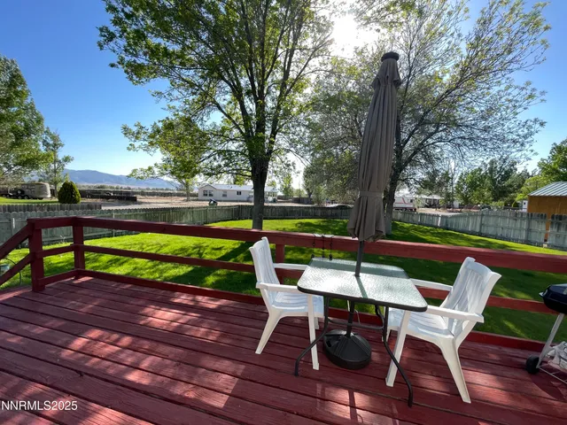 a view of a chairs and table in the patio