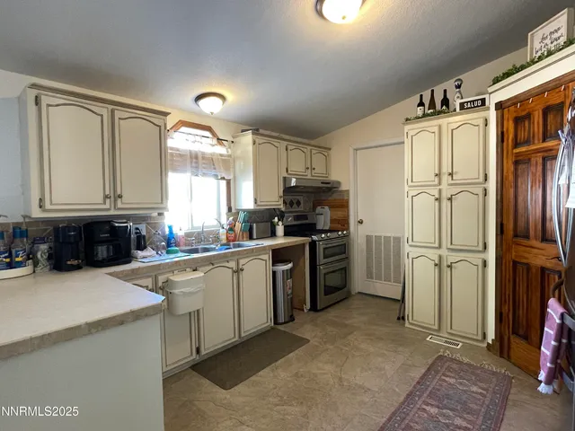 a kitchen with a refrigerator a sink and cabinets