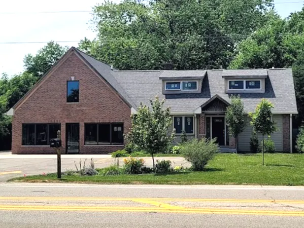 a front view of a house with a yard