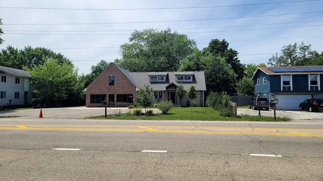 a house with a yard and a large parking space