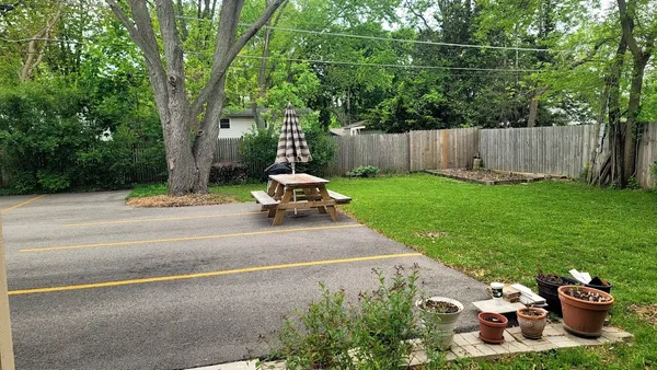 a view of a patio with a table and chairs and a fire pit