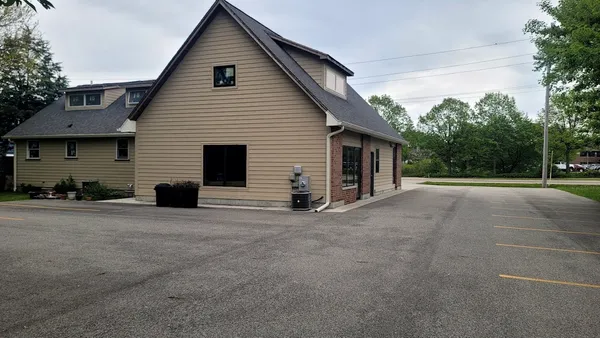 a view of a house with backyard and a garage