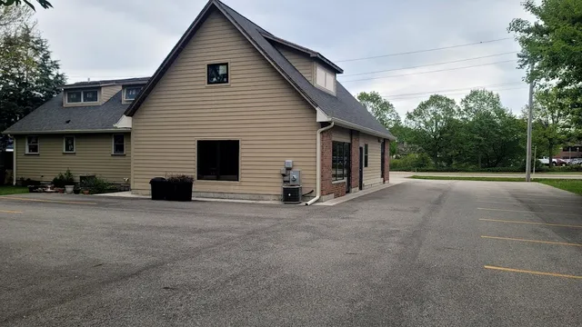 a view of a house with backyard and a garage