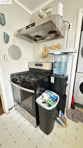 a kitchen with a stove and a wooden floor