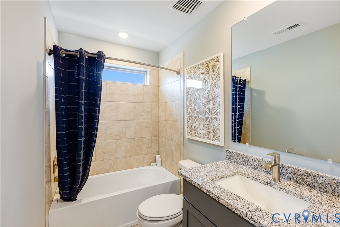 6115 Primrose Path Road Richmond, VA 23225 - Photo 16 of 23 a bathroom with a granite countertop sink toilet and shower