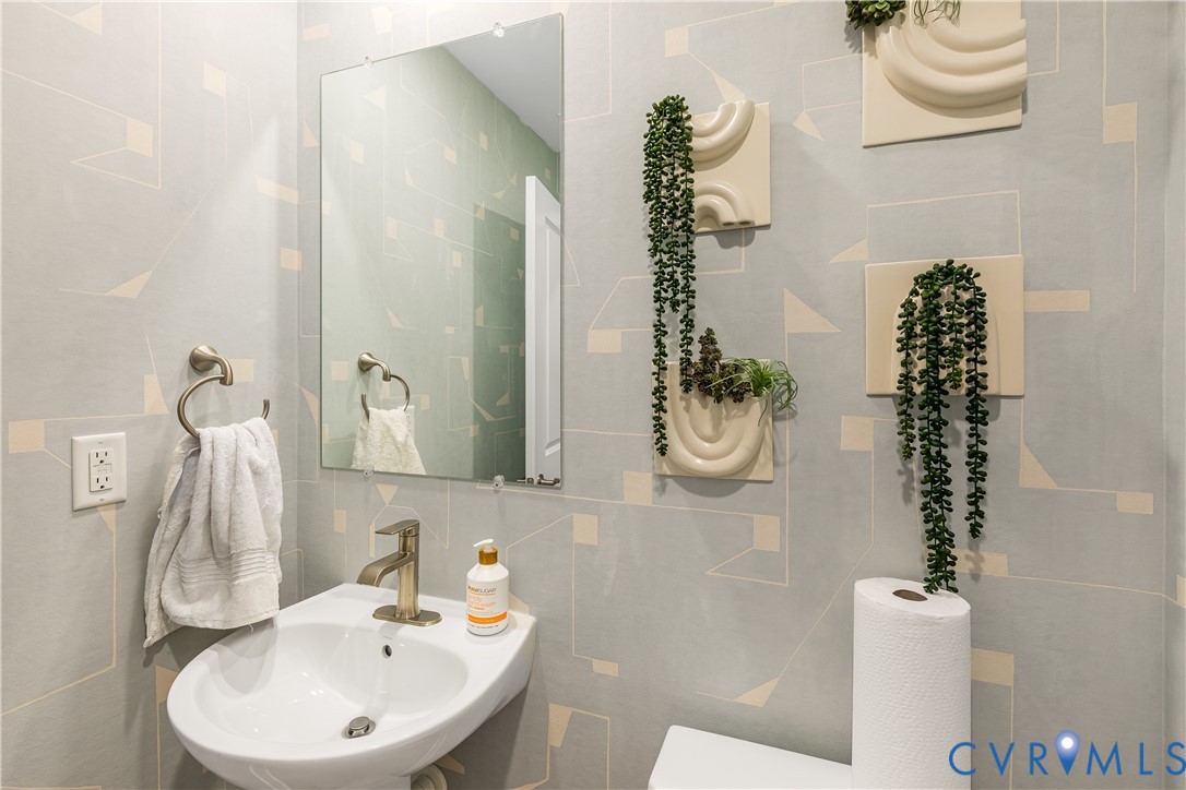 6115 Primrose Path Road Richmond, VA 23225 - Photo 18 of 23 a bathroom with a sink a toilet and a mirror