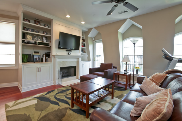 1255 West Addison Street, Unit 3 Chicago, IL 60613 - Photo 2 of 13 a living room with furniture a flat screen tv and a fireplace