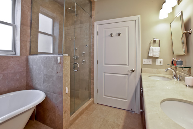 1255 West Addison Street, Unit 3 Chicago, IL 60613 - Photo 9 of 13 a bathroom with a granite countertop sink toilet and shower