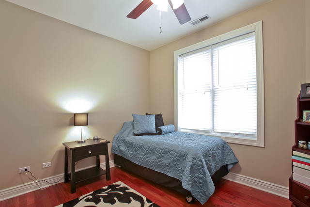 1255 West Addison Street, Unit 3 Chicago, IL 60613 - Photo 10 of 13 a bedroom with a bed and a window