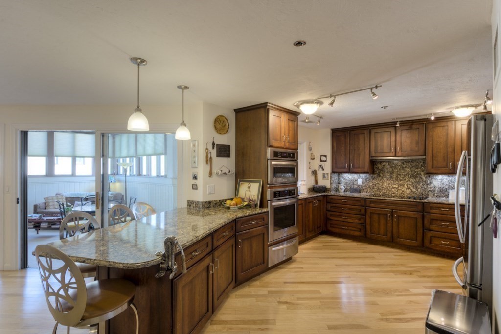 44 Elm Street, Unit 501 Worcester, MA 01609 - Photo 11 of 41 a kitchen with stainless steel appliances kitchen island granite countertop a stove refrigerator and cabinets