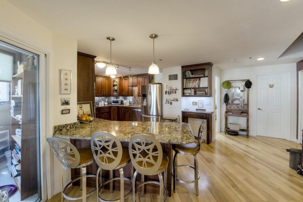 44 Elm Street, Unit 501 Worcester, MA 01609 - Photo 12 of 41 a view of a dining room with furniture and wooden floor