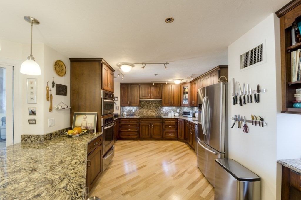 44 Elm Street, Unit 501 Worcester, MA 01609 - Photo 13 of 41 a large kitchen with stainless steel appliances lots of counter space and a refrigerator