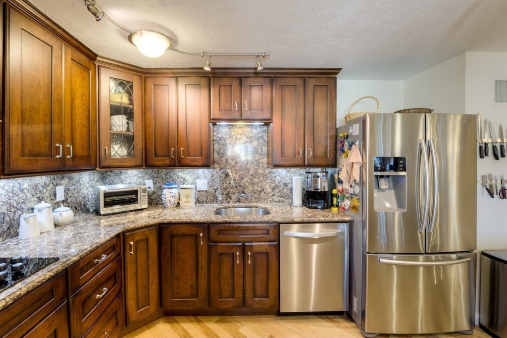 44 Elm Street, Unit 501 Worcester, MA 01609 - Photo 16 of 41 a kitchen with stainless steel appliances granite countertop a refrigerator sink and cabinets