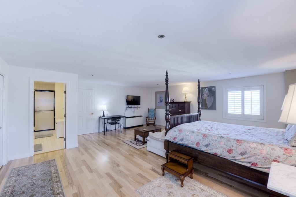 44 Elm Street, Unit 501 Worcester, MA 01609 - Photo 26 of 41 a bedroom with a bed and wooden floor