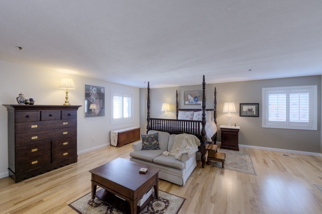 44 Elm Street, Unit 501 Worcester, MA 01609 - Photo 29 of 41 a bedroom with a bed and wooden floor