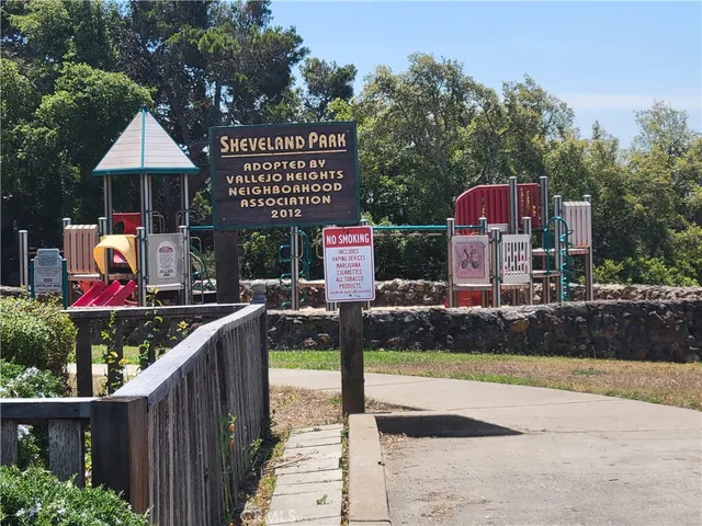 a front view of a house with yard and trees