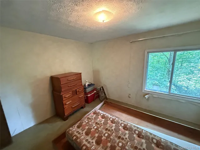 a bed sitting in a room next to a window