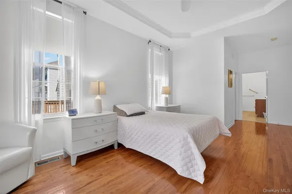 a bedroom with a bed and a large window