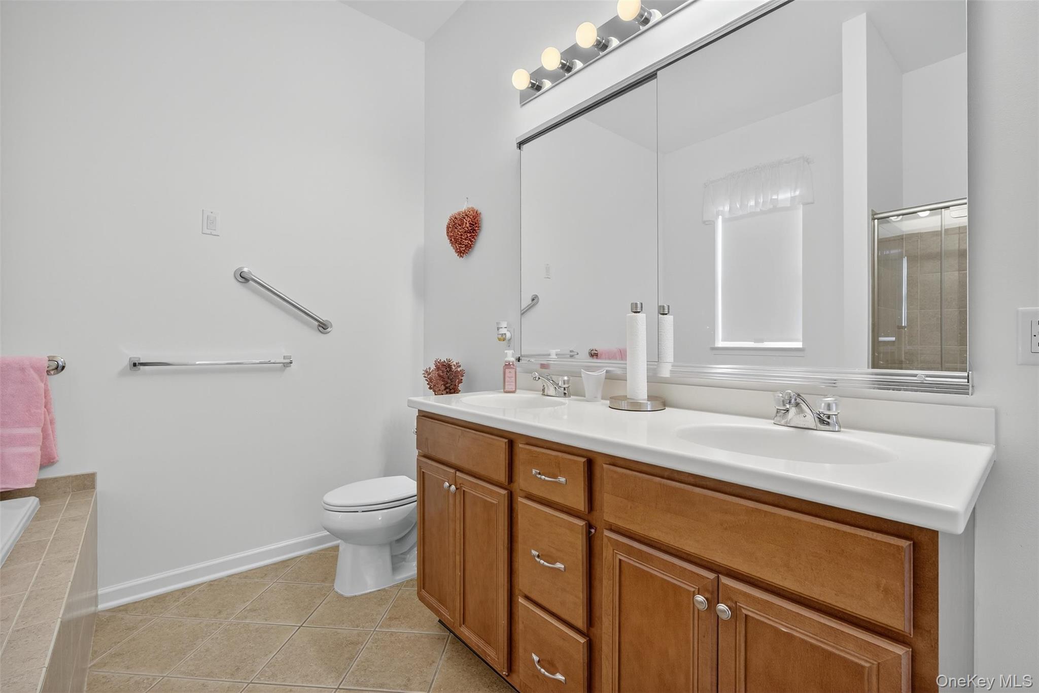 167 Stony Brook Road Fishkill, NY 12524 - Photo 18 of 42 Full bath featuring light tile patterned floors, double vanity, an enclosed shower, and a bath