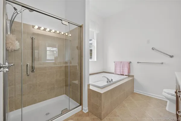 a bathroom with a sink a mirror and a glass door shower
