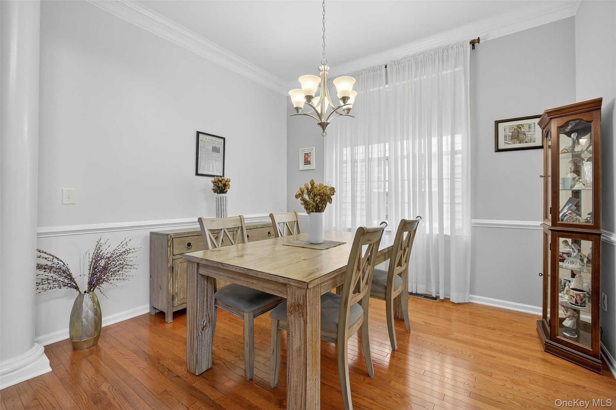 167 Stony Brook Road Fishkill, NY 12524 - Photo 4 of 42 Dining area featuring light wood finished floors, crown molding, and a chandelier