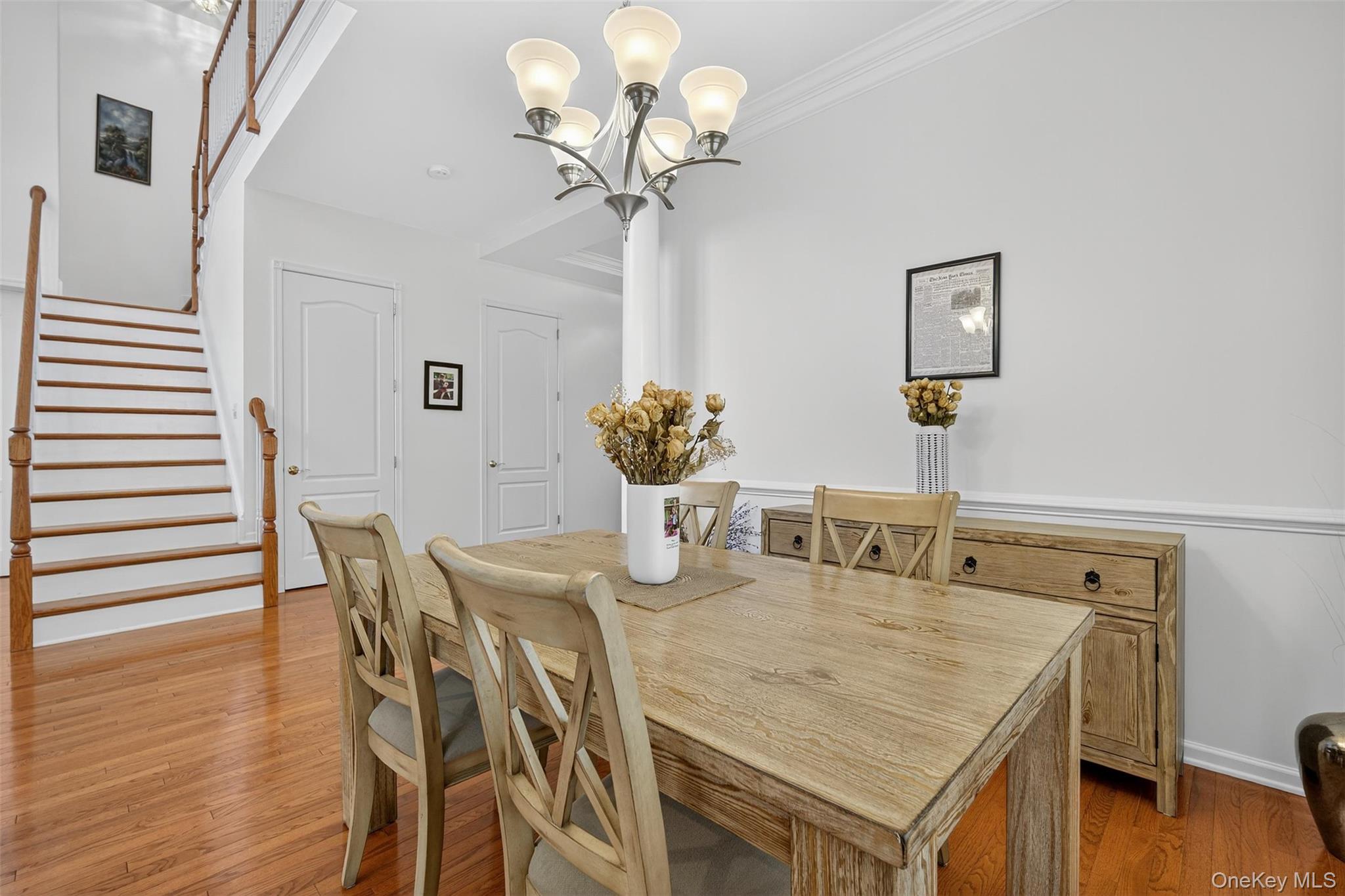 167 Stony Brook Road Fishkill, NY 12524 - Photo 5 of 42 Dining room featuring light wood-type flooring, a chandelier, stairway, and ornamental molding