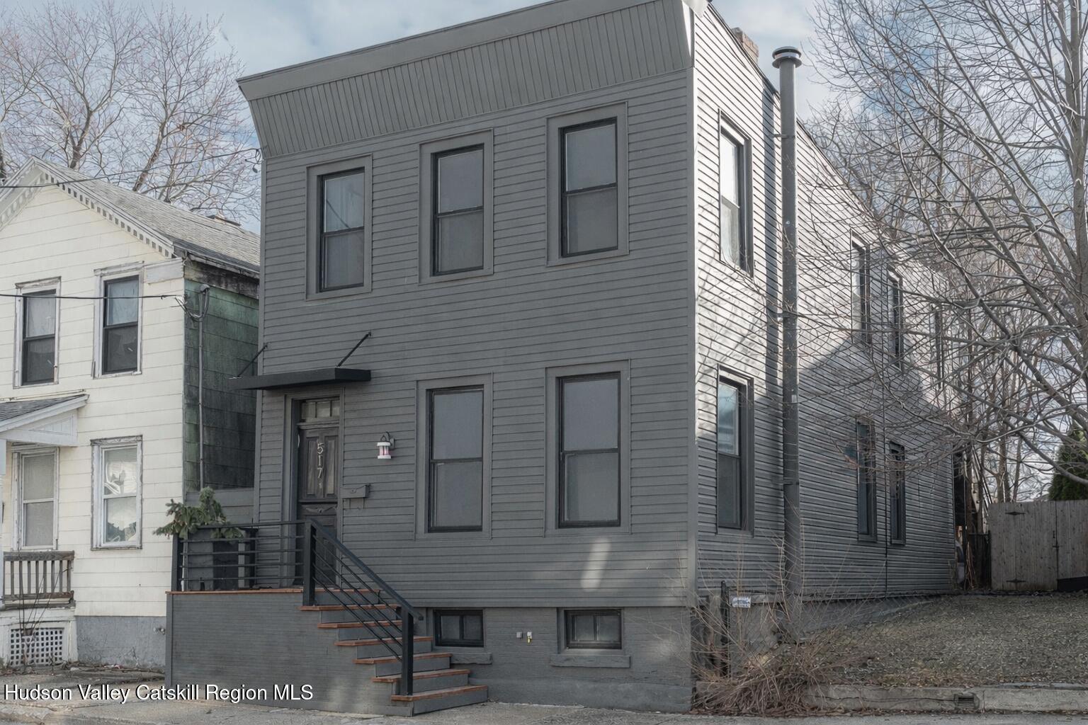 517 State Street Hudson, NY 12534 - Photo 1 of 36 a view of a wooden house with a yard and large tree